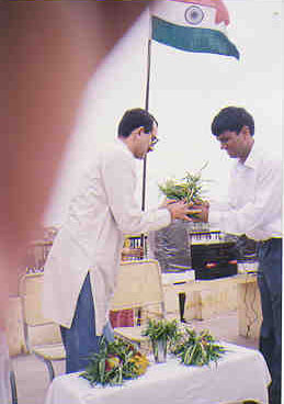 Anil Chawla receiving a bouquet