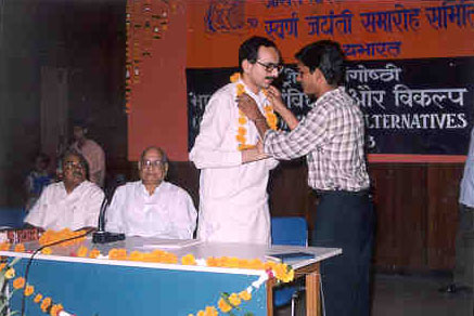 Anil Chawla being welcomed by garland
