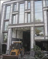 Bulldozer ready for demolishing a mall at MG Road, Delhi