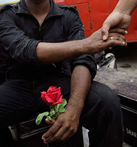 Commando soldier with a rose in hand, after finishing operation against terrorists at Hotel Taj in Mumbai.