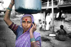 Old poor woman using mobile telephone